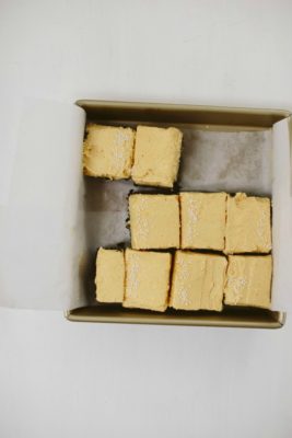 chocolate snack cake with pumpkin buttercream in a square pan, slices cut