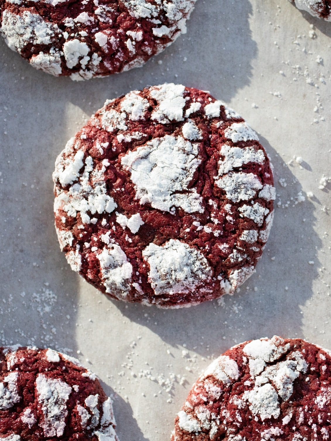 red velvet crinkle cookies on parchment paper