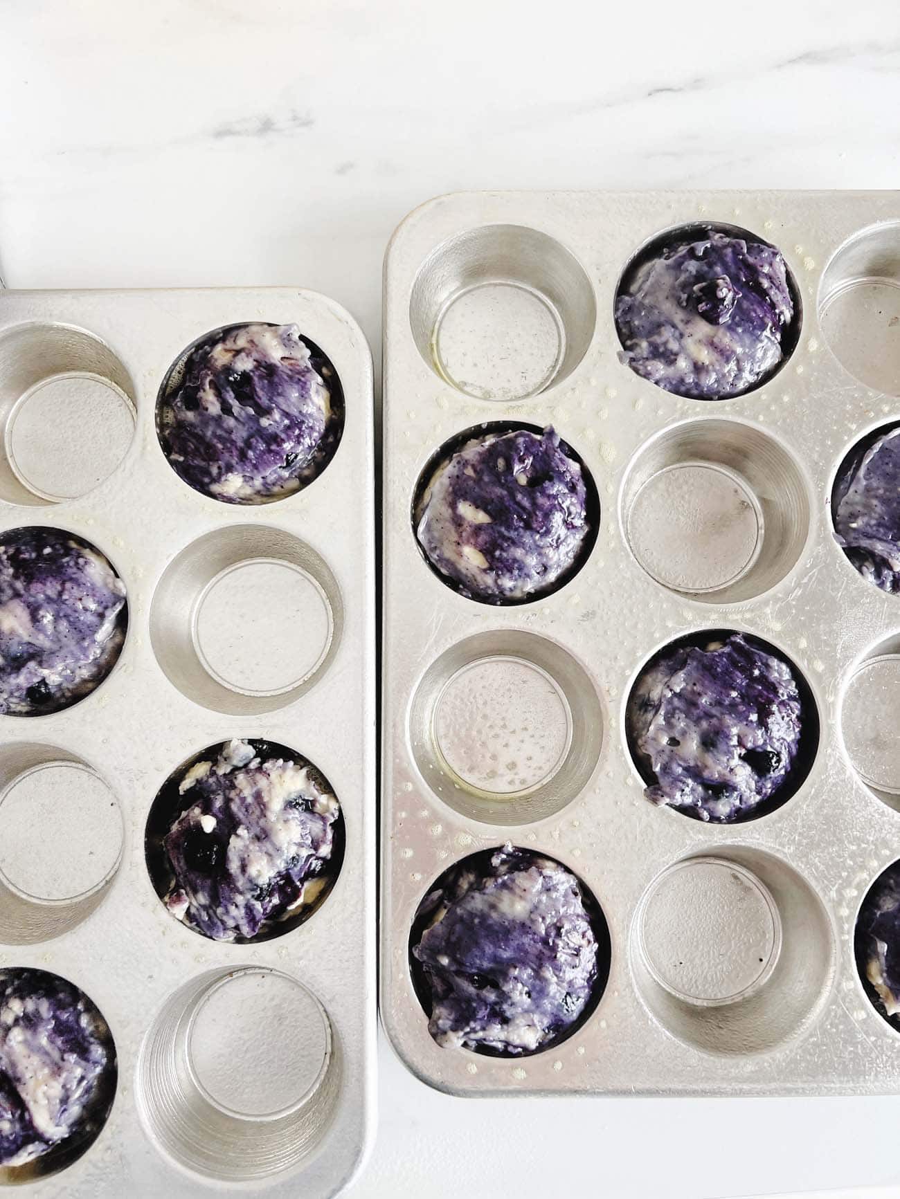 blueberry muffin batter in muffin tin 