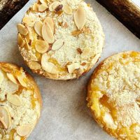 mini almond coffee cakes on a baking sheet