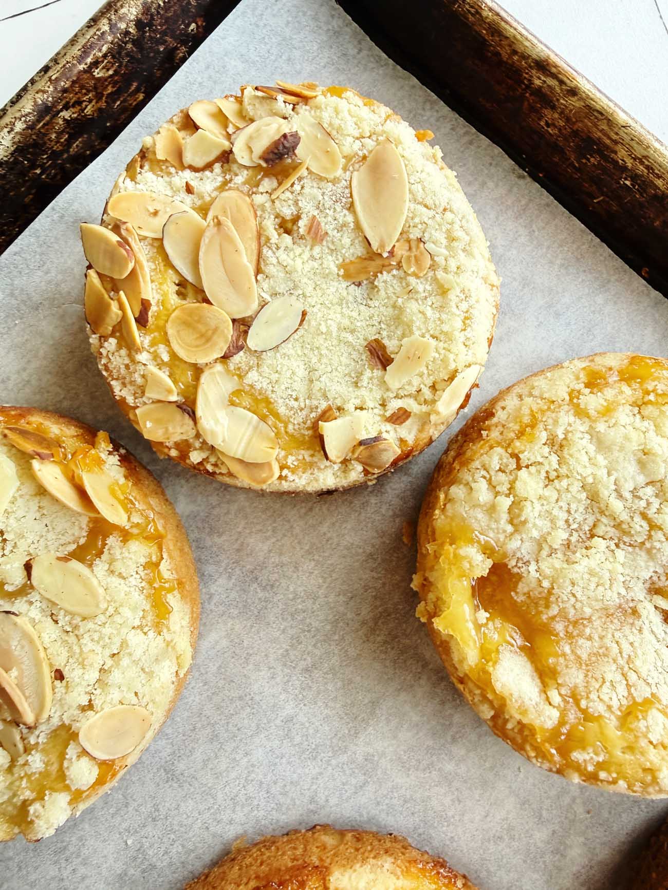 mini almond coffee cakes on a baking sheet